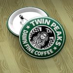 Twin Peaks, Starbucks Coffee 1.25 round button pin. Laura Palmer, wrapped in plastic, Damn Fine Coffee quote from Dale Cooper and Black Lodge symbol at top.